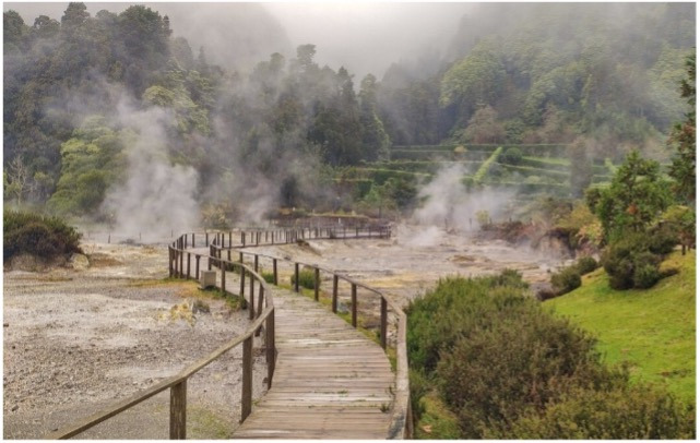 Wooden boardwalk through geothermal area with steam vents, Sul Villas & Spa.