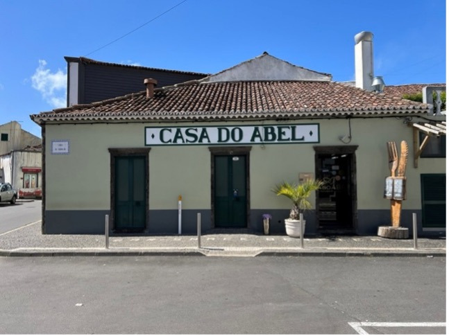 Casa do Abel Sul Villas & Spa - charming Portuguese guesthouse exterior with tiled roof and vibrant signage.