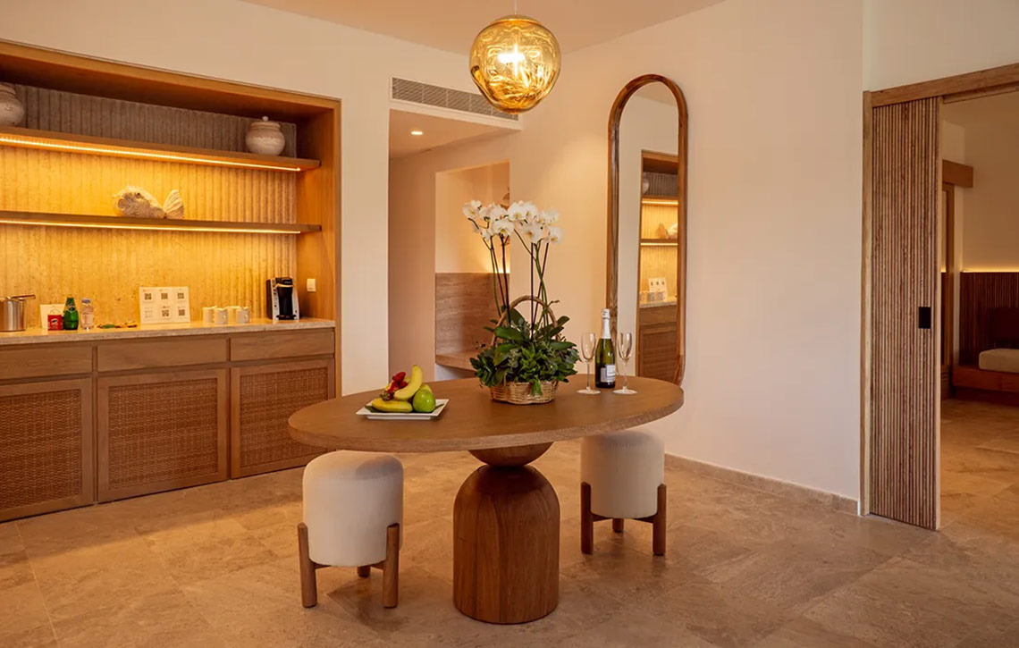 Luxury Hacienda Tres Rios suite: fruit, champagne, and elegant decor.
