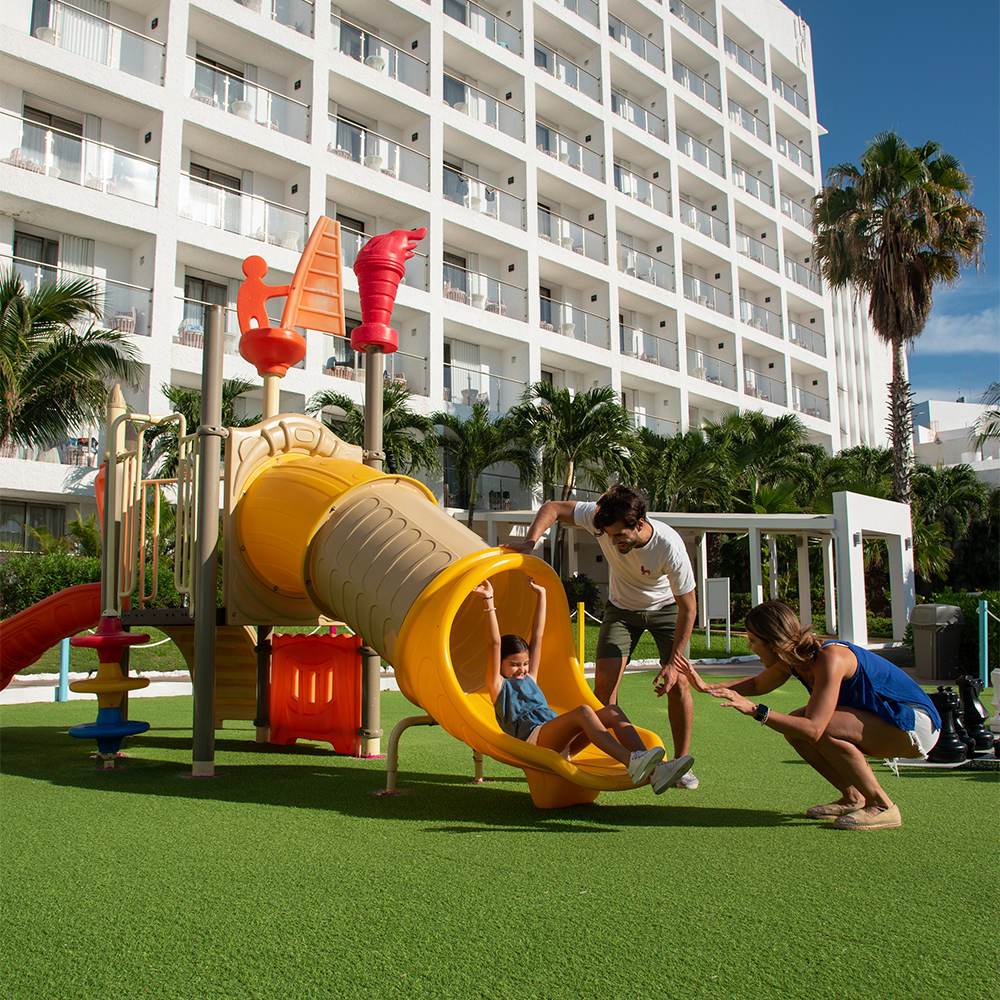 Pareja ejercitándose en gimnasio con vista al mar en Sunset World Resorts