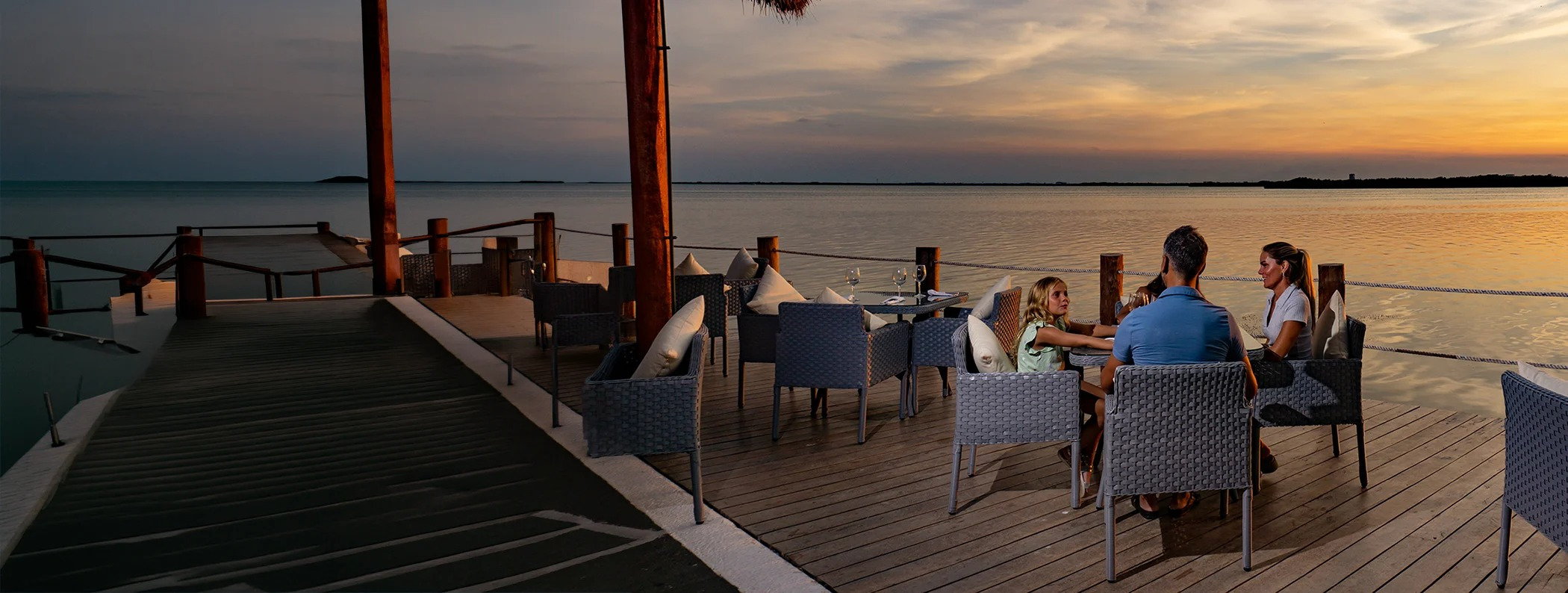 Sunset dining at a waterfront hotel: enjoy outdoor seating and serene views. Sunset Hotels Collection: Corporativa