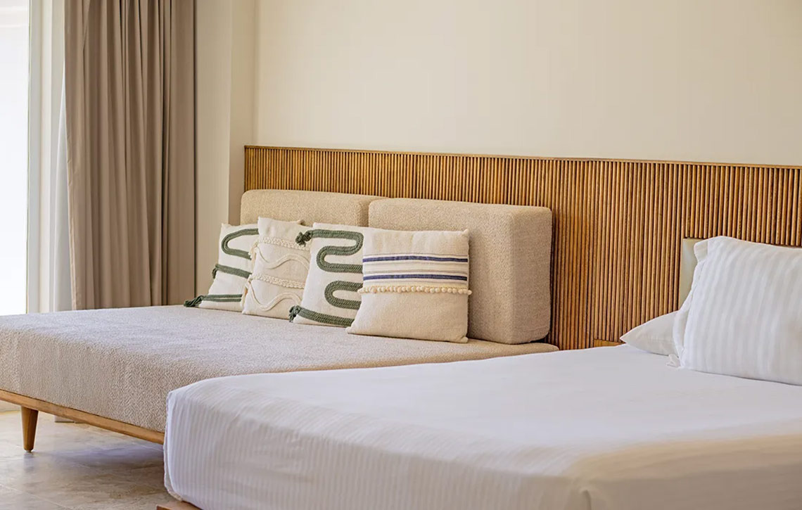 Stylish bedroom at Hacienda Tres Rios with plush bedding and decorative pillows.