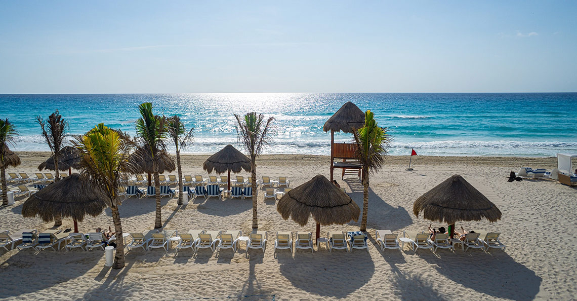 Beach chairs and umbrellas at Sunset Royal Beach Resort.