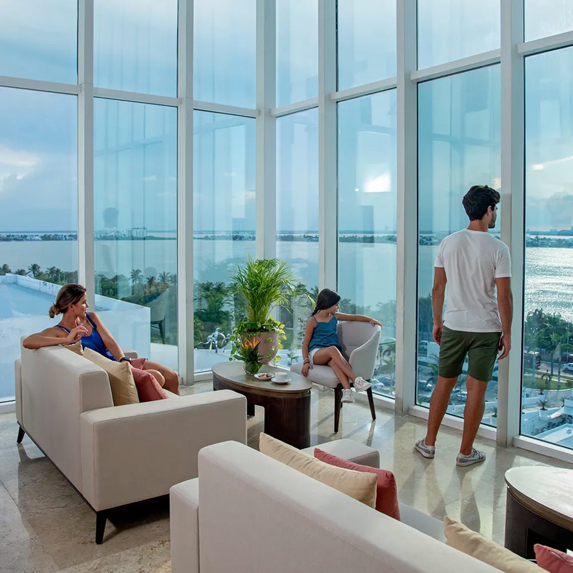 Family enjoying the view from their room at Sunset Royal Beach Resort.