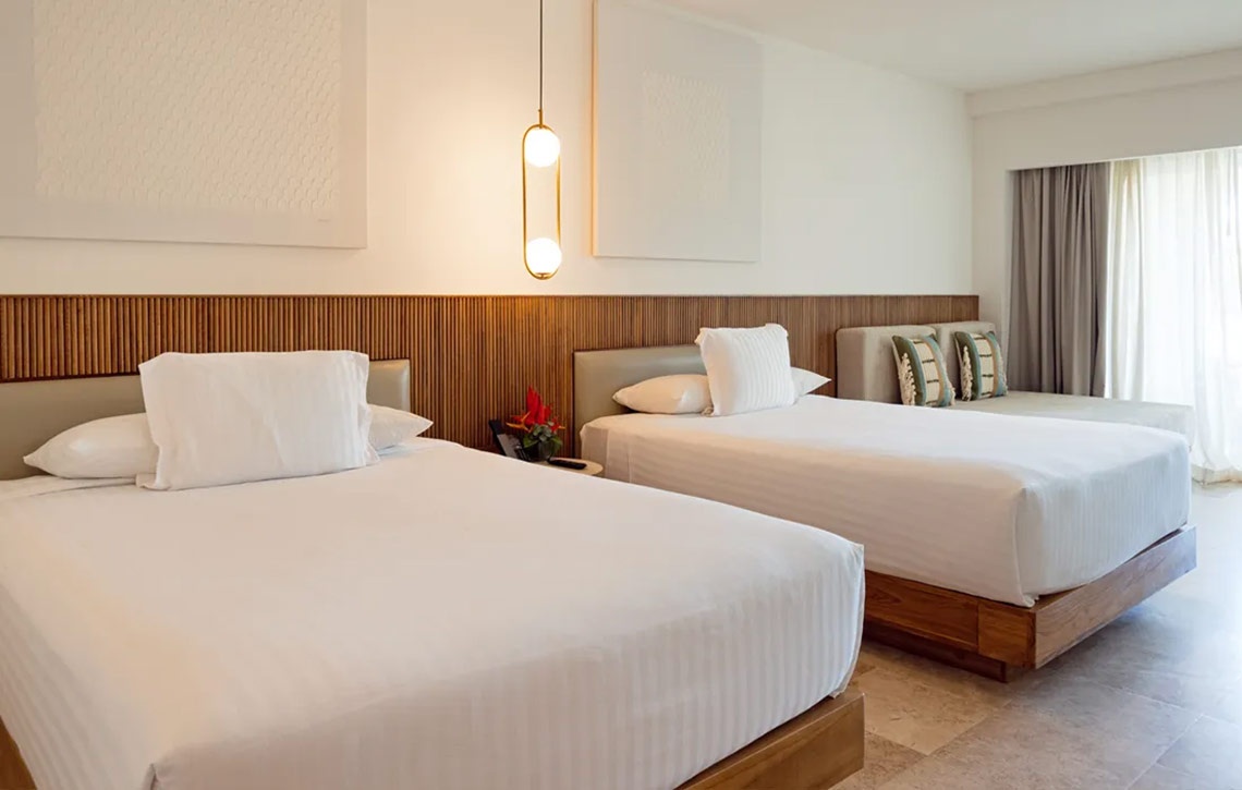 Spacious Hacienda Tres Rios room with two queen beds and modern decor.
