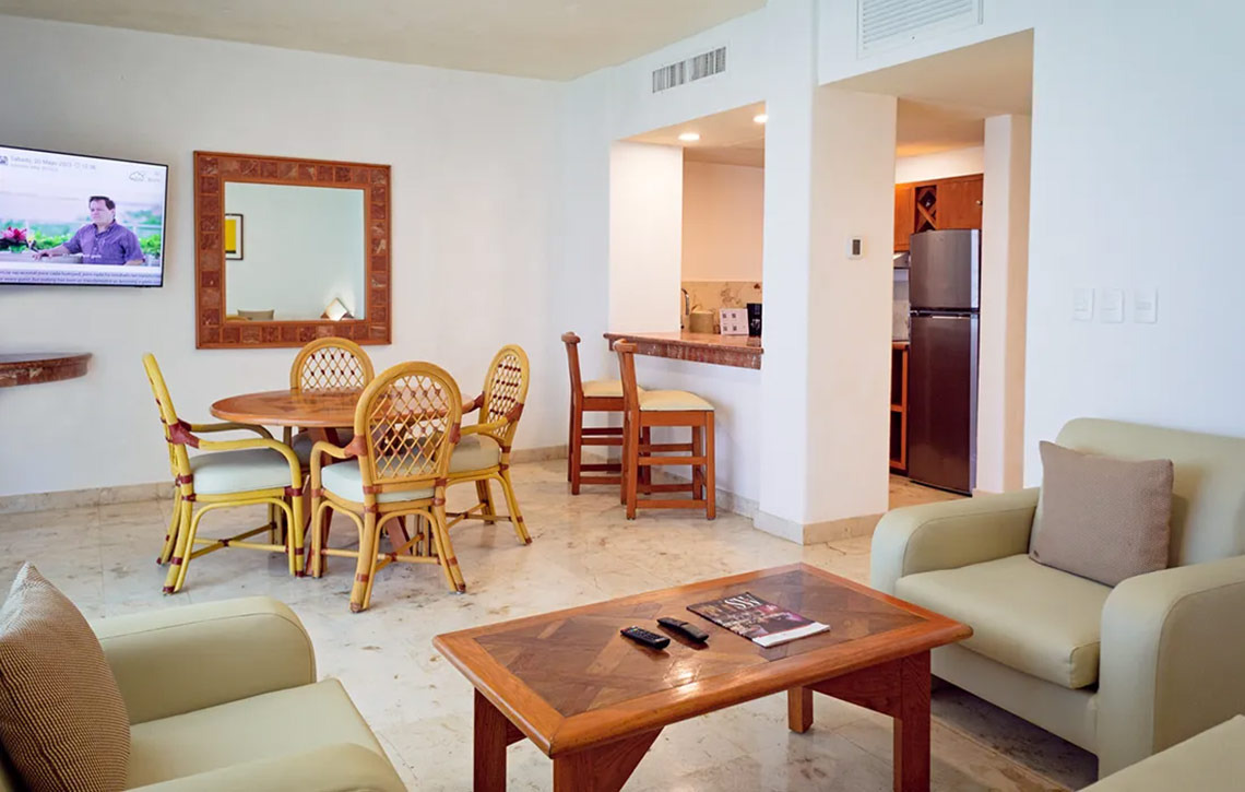 Sala de estar del Sunset Fishermen Beach Resort con comedor y cocina.