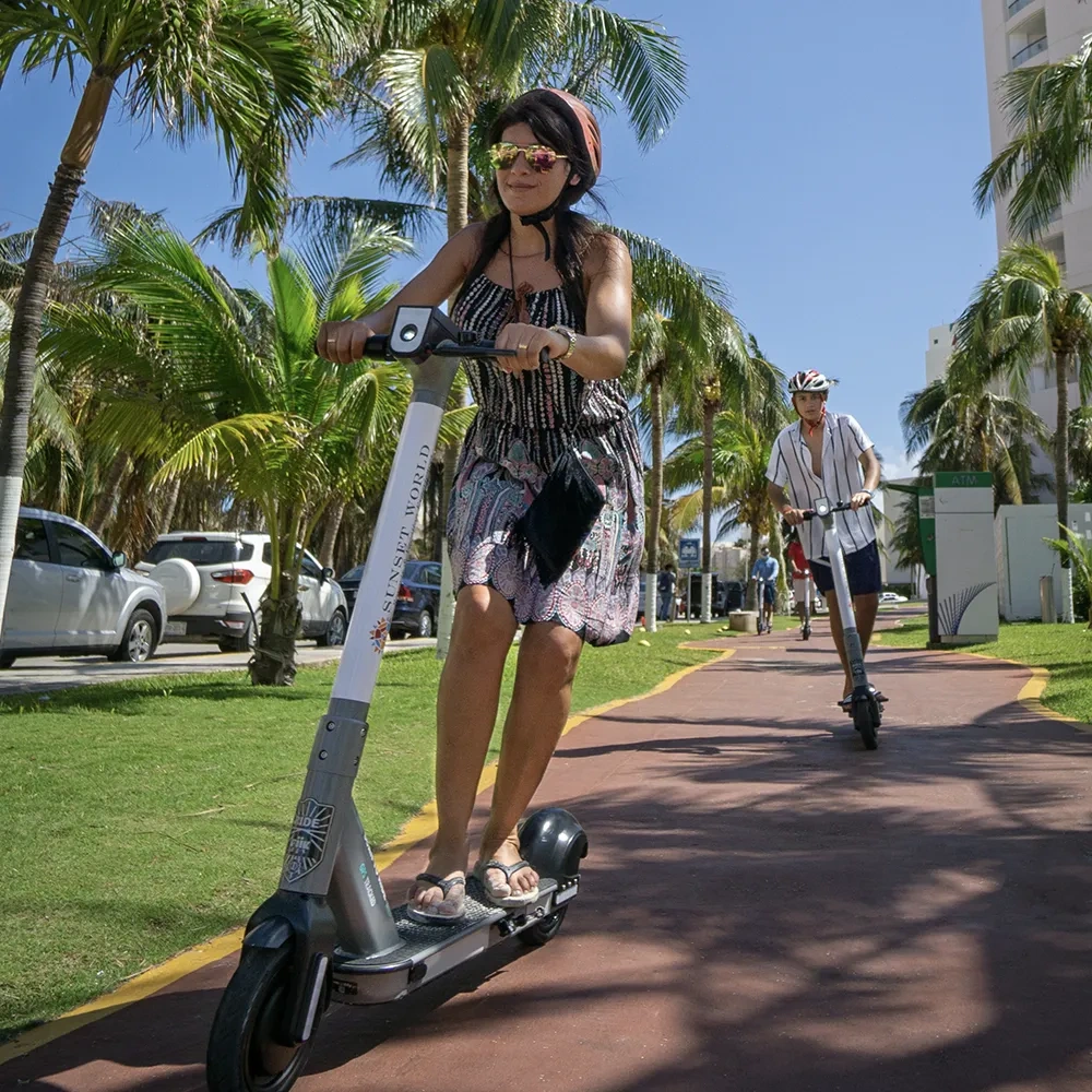 Sunset World Resorts: Corporativa guests enjoy electric scooters along tropical paths.