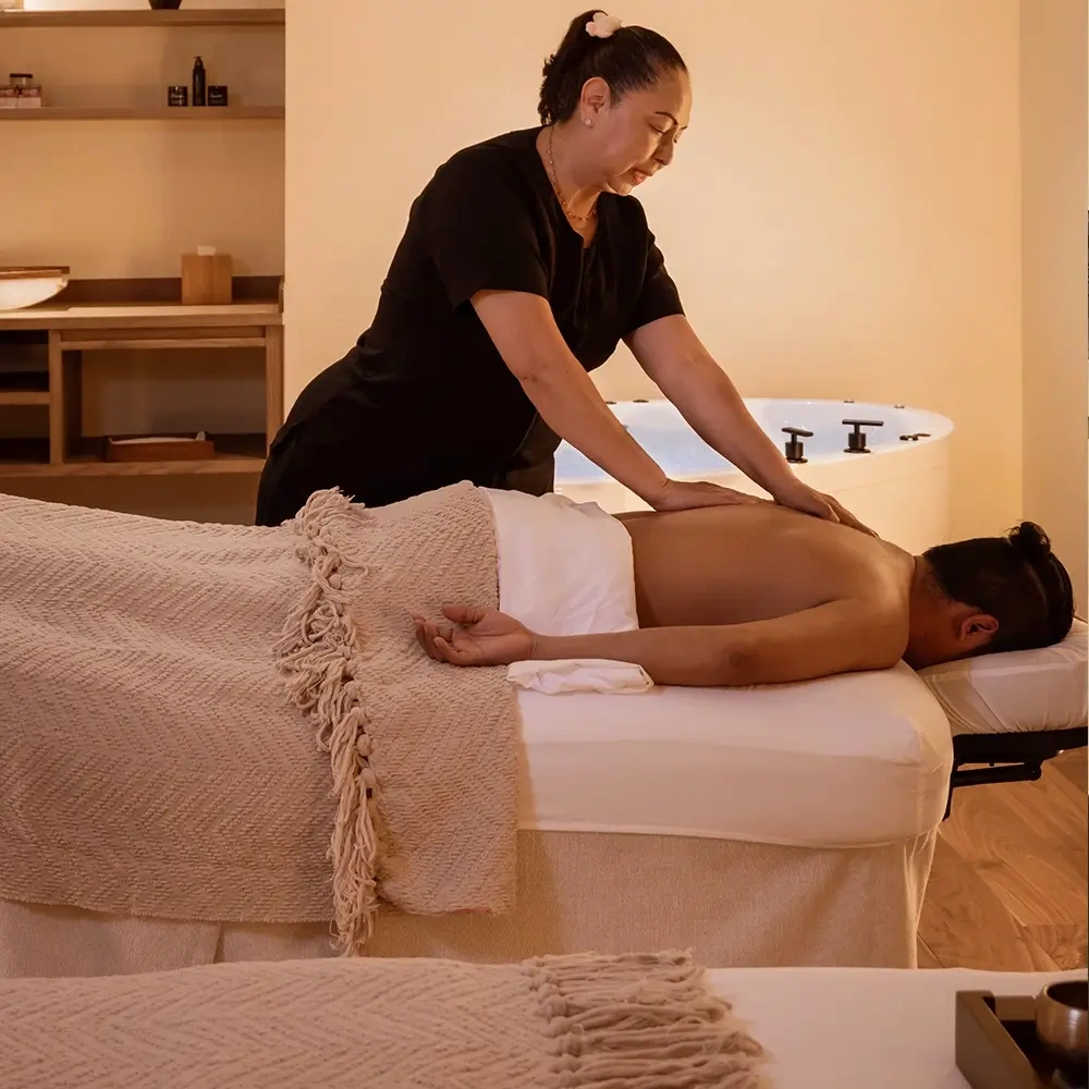 Relaxing Sunset Hotels Collection: Corporativa in a serene spa with a massage therapist.