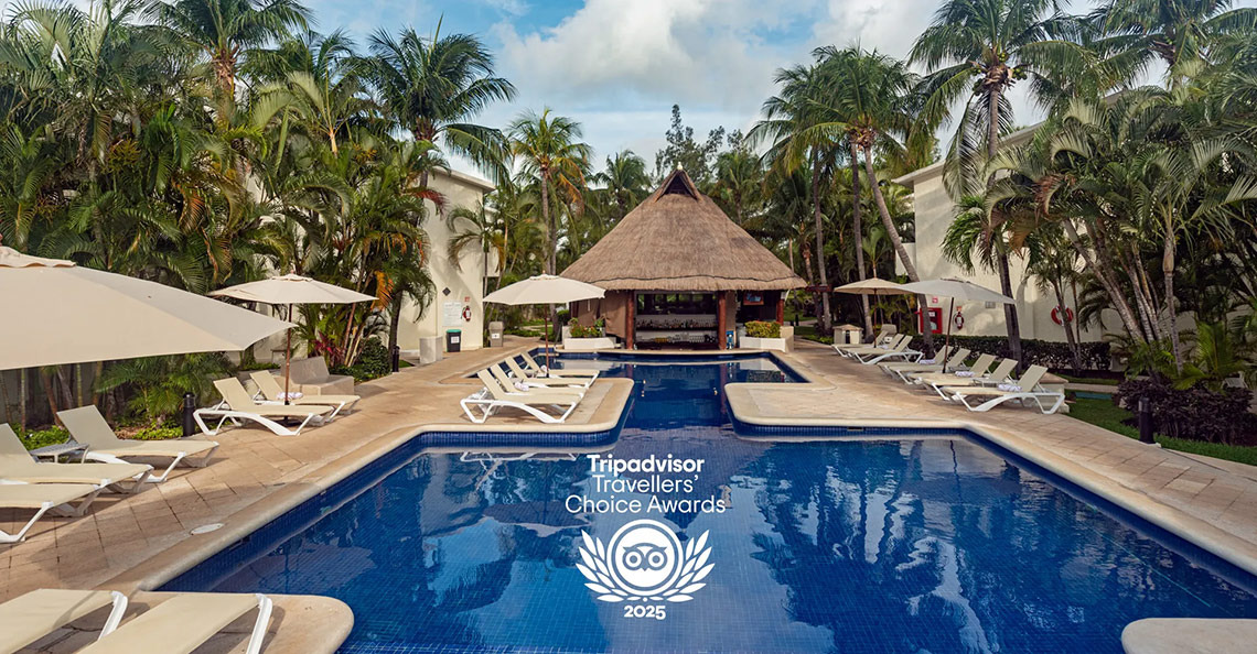 Laguna Suites: Piscina y área de descanso con palmeras, award 2025.