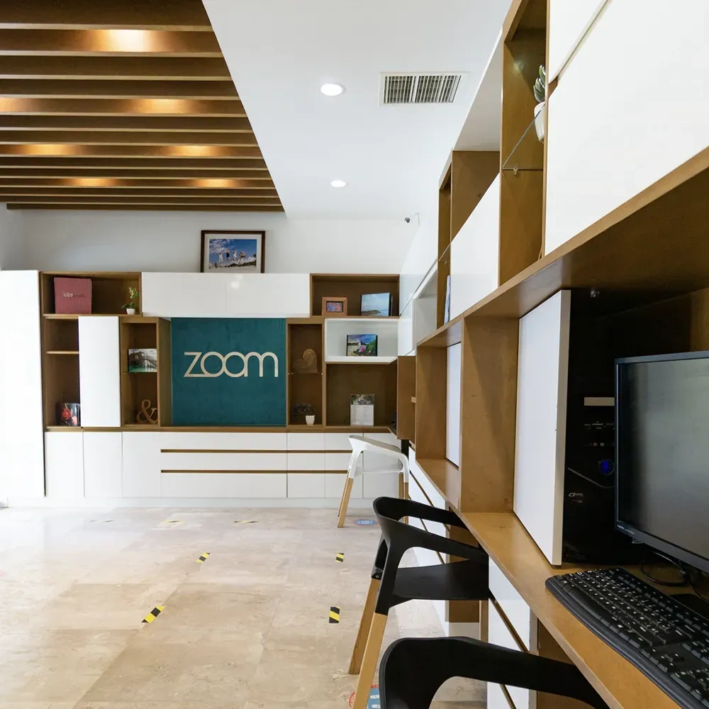 Modern office with Sunset Hotels Collection: Corporativa logo and workstations.