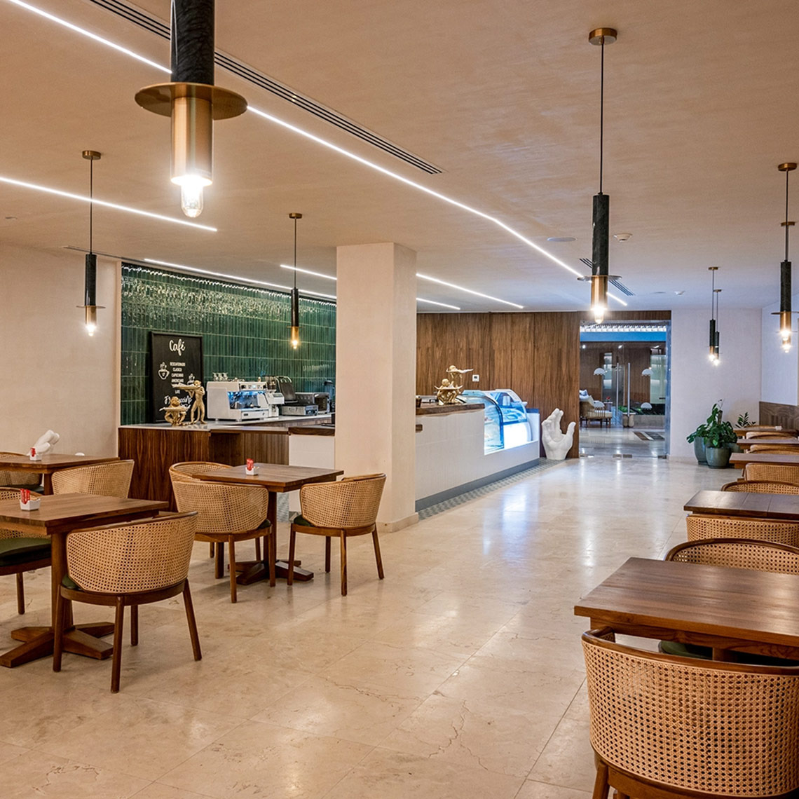 Chic cafe at Hacienda Tres Rios with rattan seating and modern lighting.