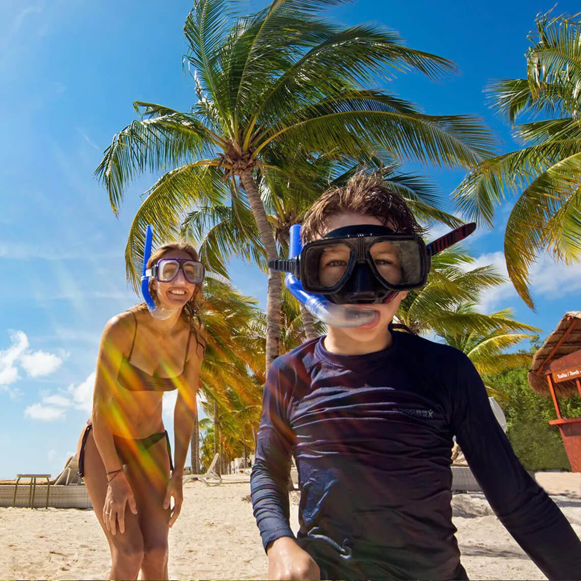Happy kids snorkeling on a sunny beach vacation at Hacienda Tres Rios.