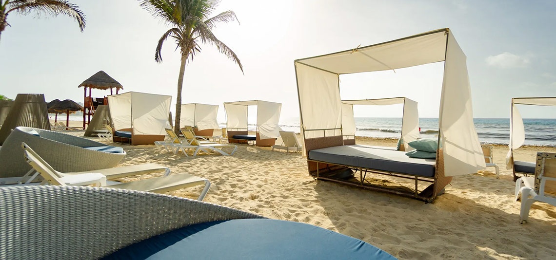 Beachfront cabanas at Sunset Royal Beach Resort, perfect for a relaxing getaway.