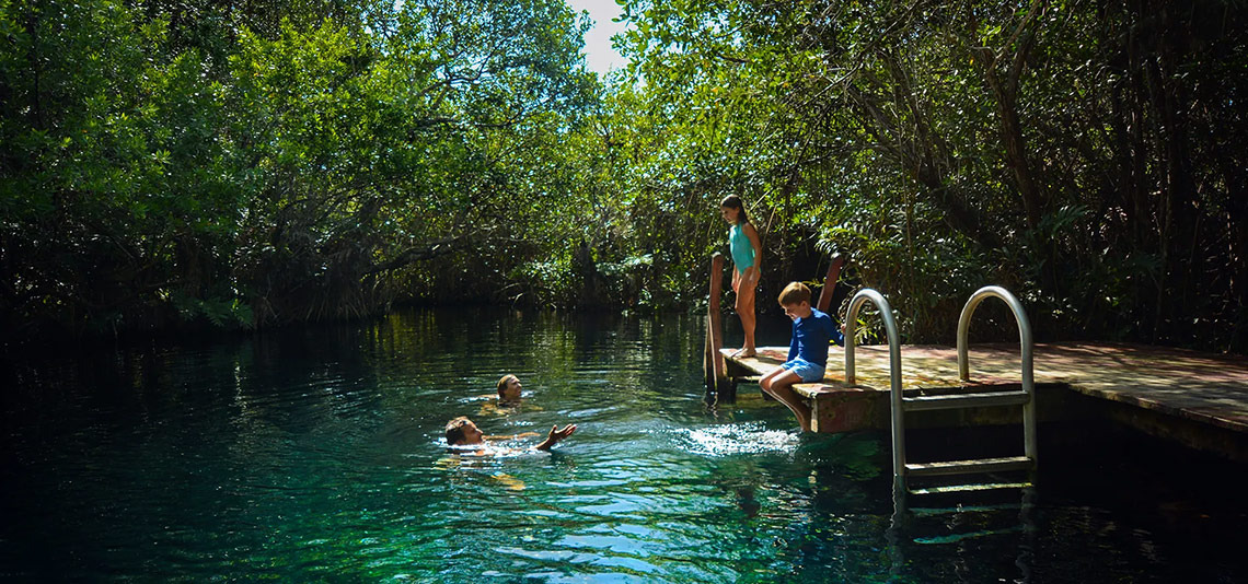 Family fun at Hacienda Tres Rios: swim in clear waters or dive from the dock.