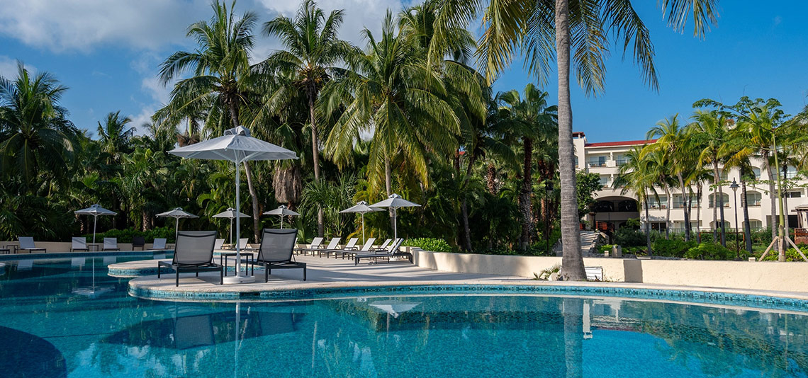 Hacienda Tres Rios resort pool and palapas, a perfect vacation escape.