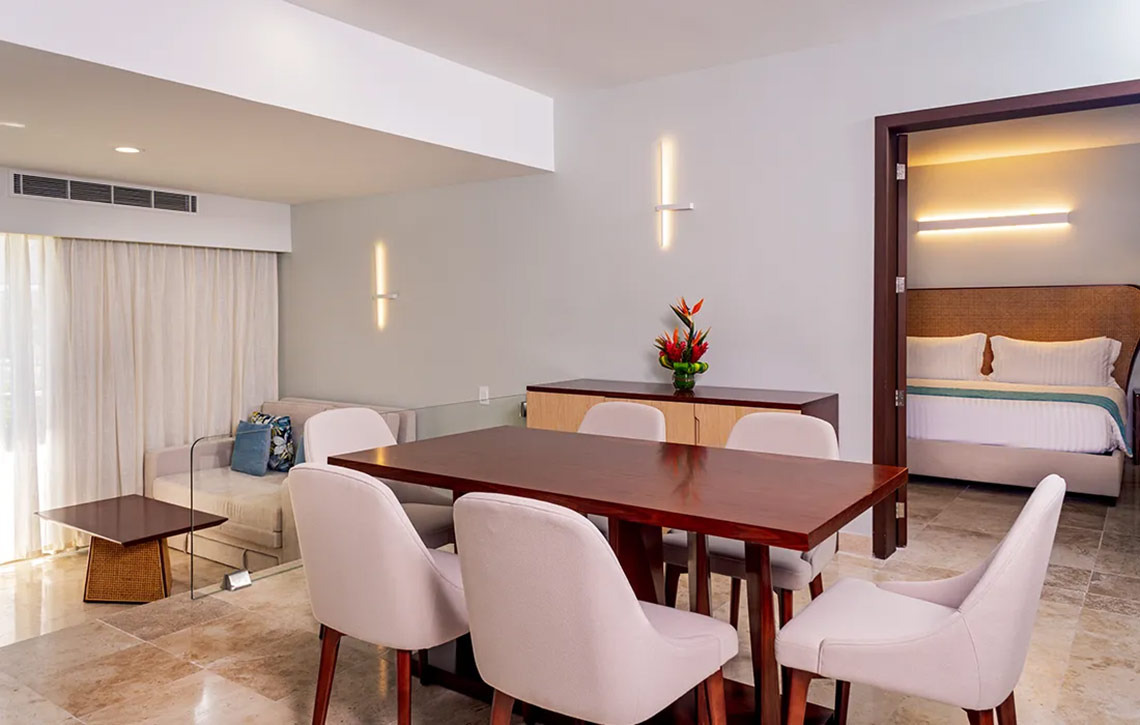 Sunset Royal Beach Resort: Spacious suite with dining area, living room, and separate bedroom.