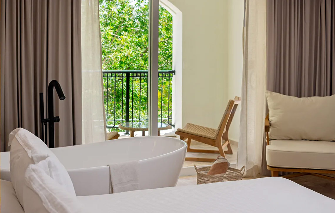 Luxury bathroom suite with soaking tub and balcony at Hacienda Tres Rios.