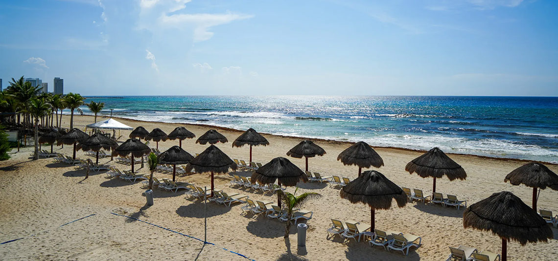 Beach umbrellas and lounge chairs at Sunset Royal Beach Resort, Cancun.