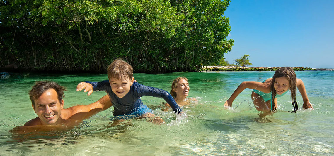 Family fun at Hacienda Tres Rios | Official Page: swimming in clear turquoise waters.
