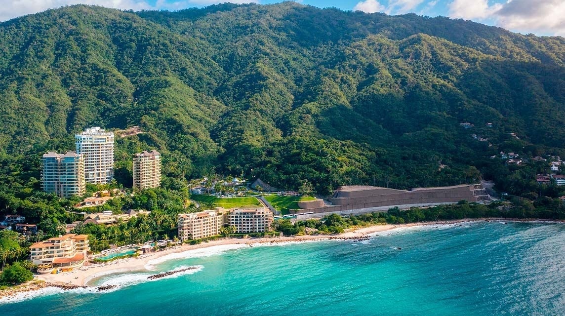 a large swimming pool surrounded by palm trees and buildings