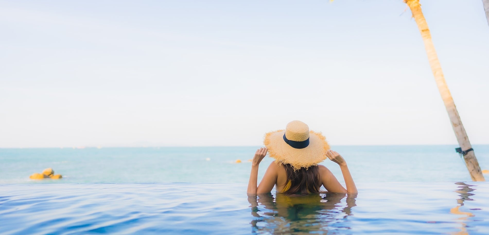 a woman laying on a beach with her legs crossed
