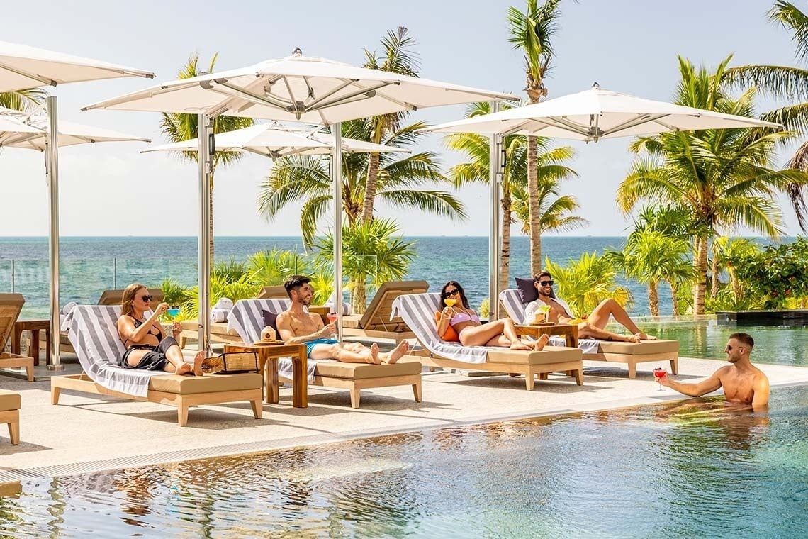 a man and a woman standing next to a surfboard that says surftech