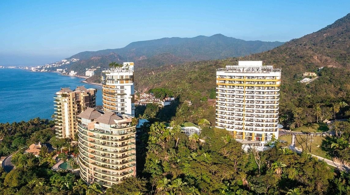 a large swimming pool surrounded by palm trees and buildings