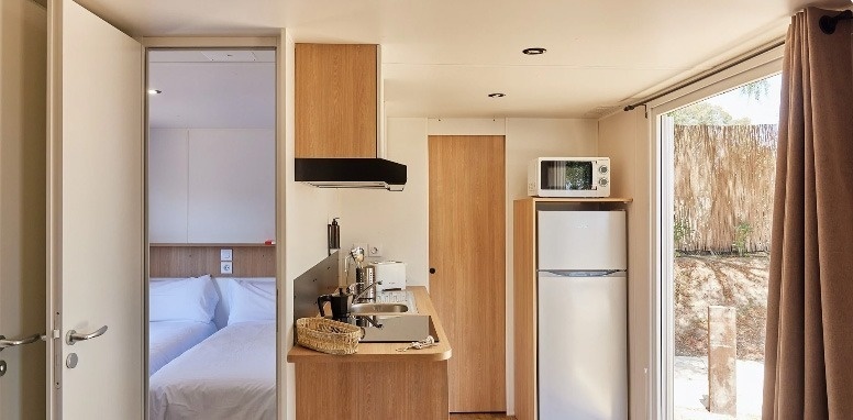 a kitchen with a sink a refrigerator and a microwave