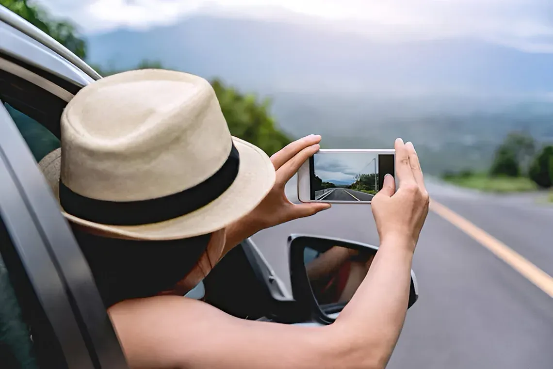 Traveler at The Fives Corpo captures road photo with smartphone