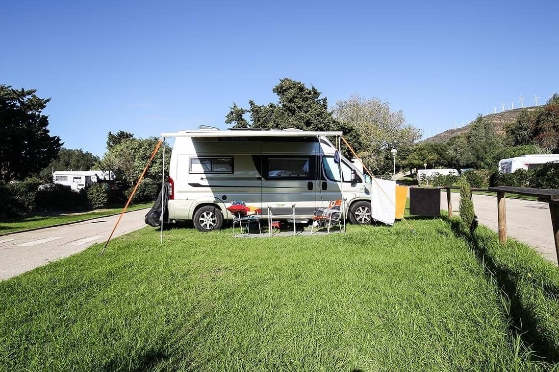 a camper van is parked in a grassy area