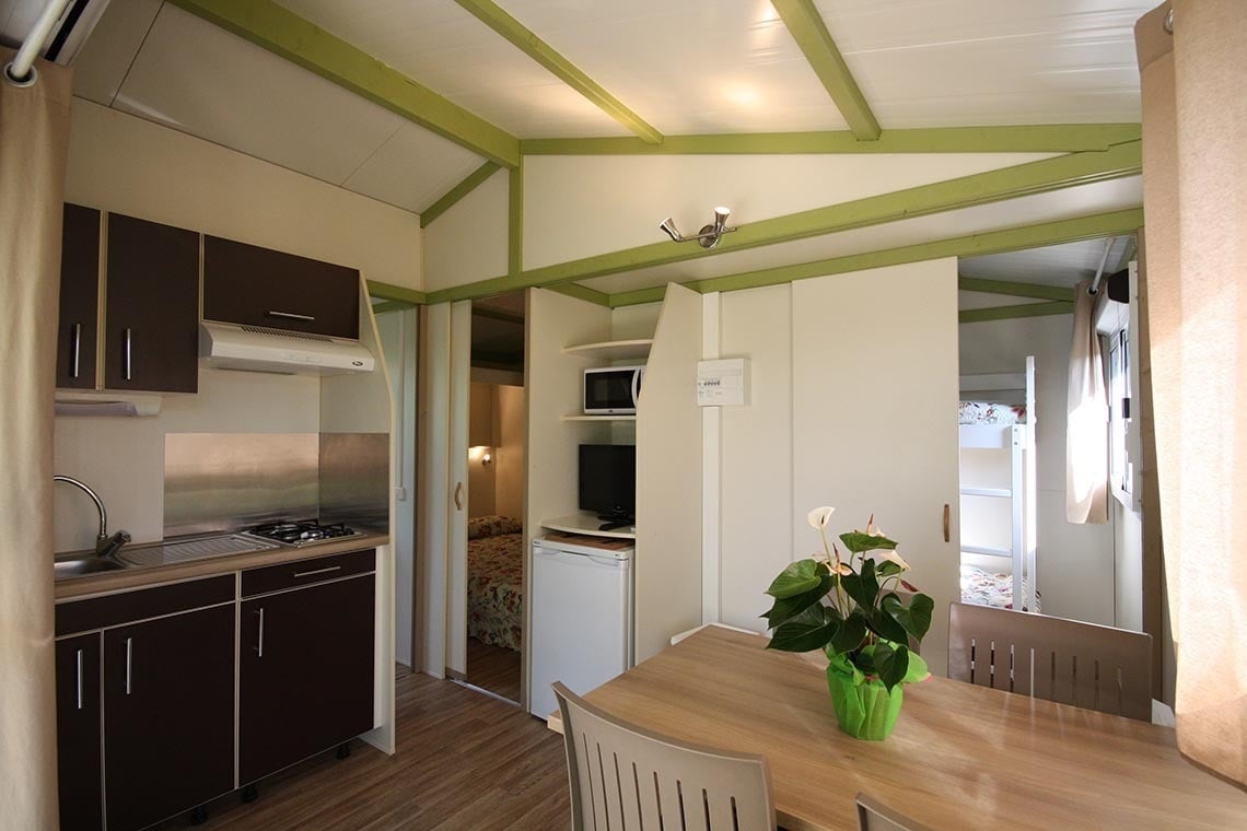 a kitchen with a stove top oven and a refrigerator