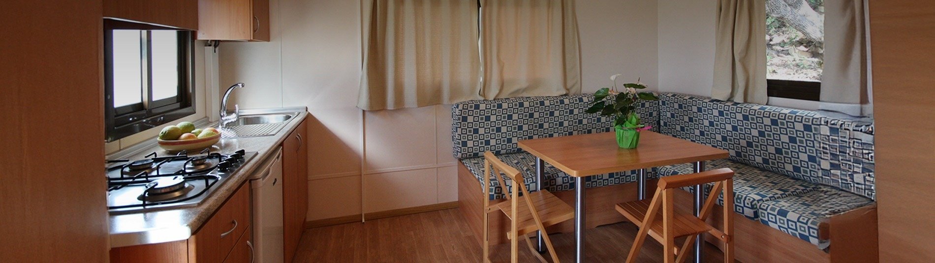 a room with chairs and a table with a chandelier on the wall