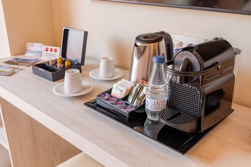 una mesa con una máquina de café y una botella de agua