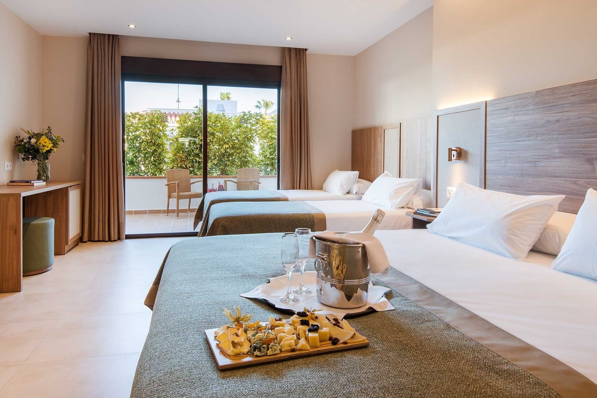 a hotel room with two beds and a tray of food on the bed