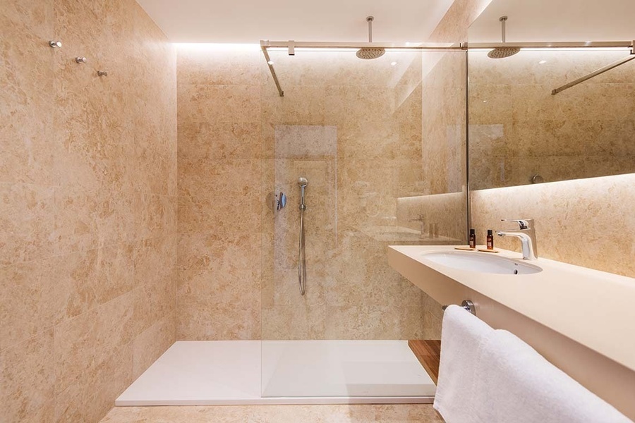 un baño con un lavabo y una ducha de vidrio