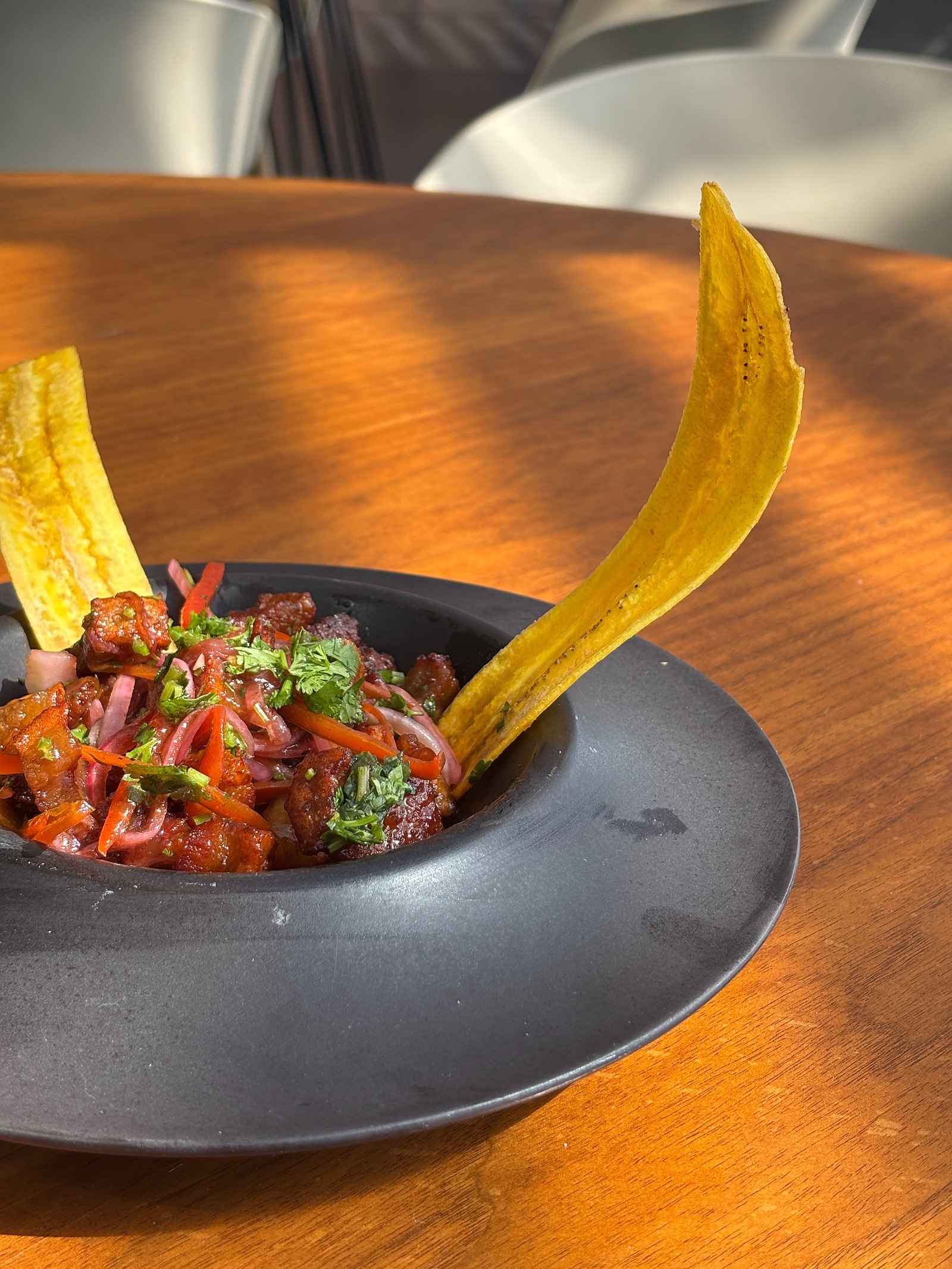 Tequendama Corporativa: Delicious ceviche served with plantain chips on a wooden table.