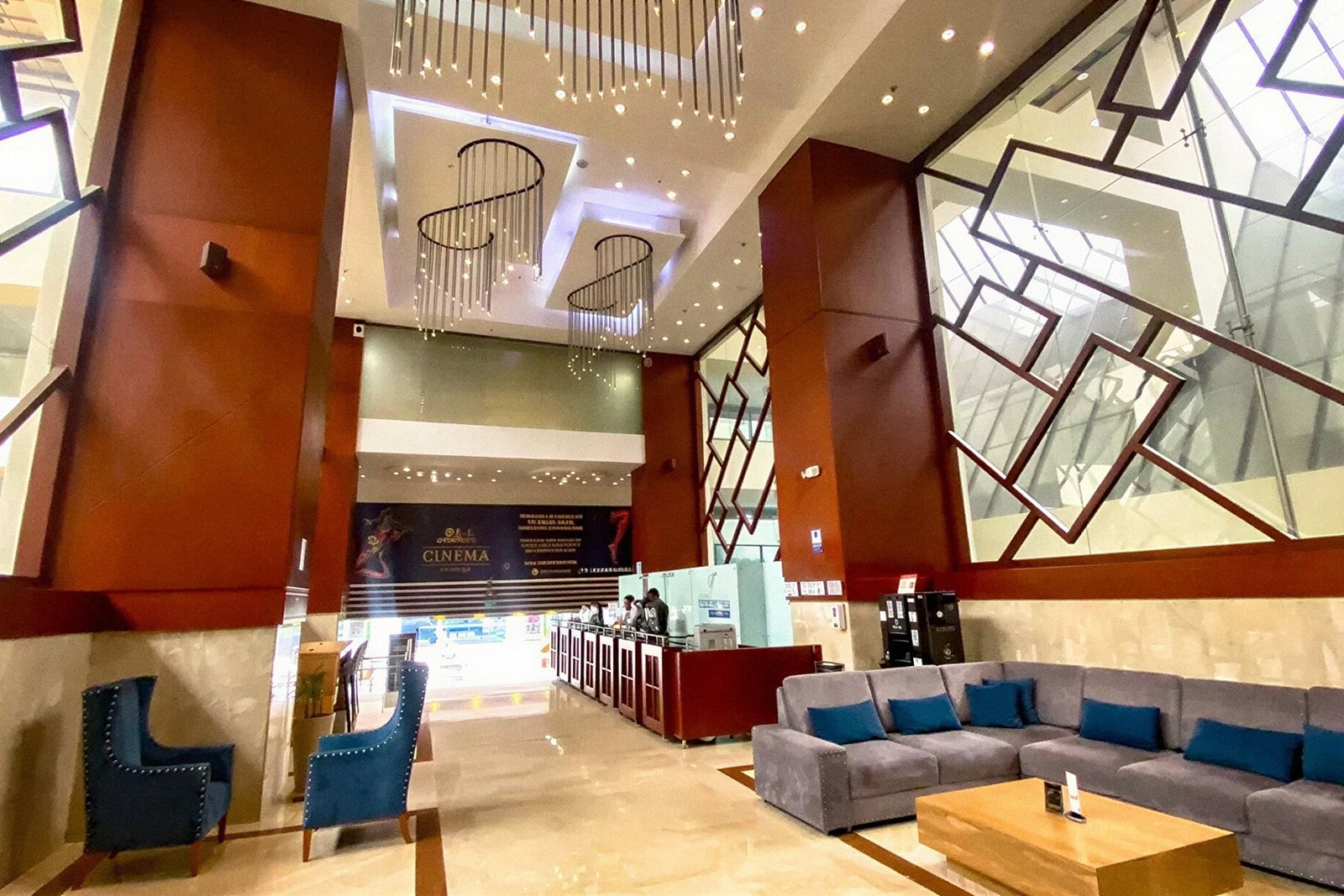 Spacious lobby of Tequendama Suites Bogotá: modern seating, cinema entrance, and stylish lighting.
