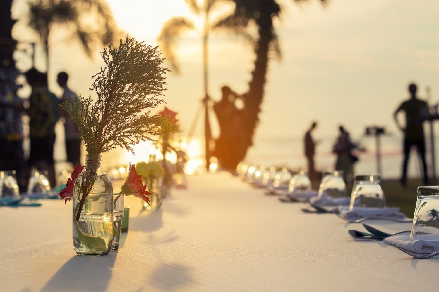 Tequendama Corporate banquet at sunset, event table with flowers and ocean view.