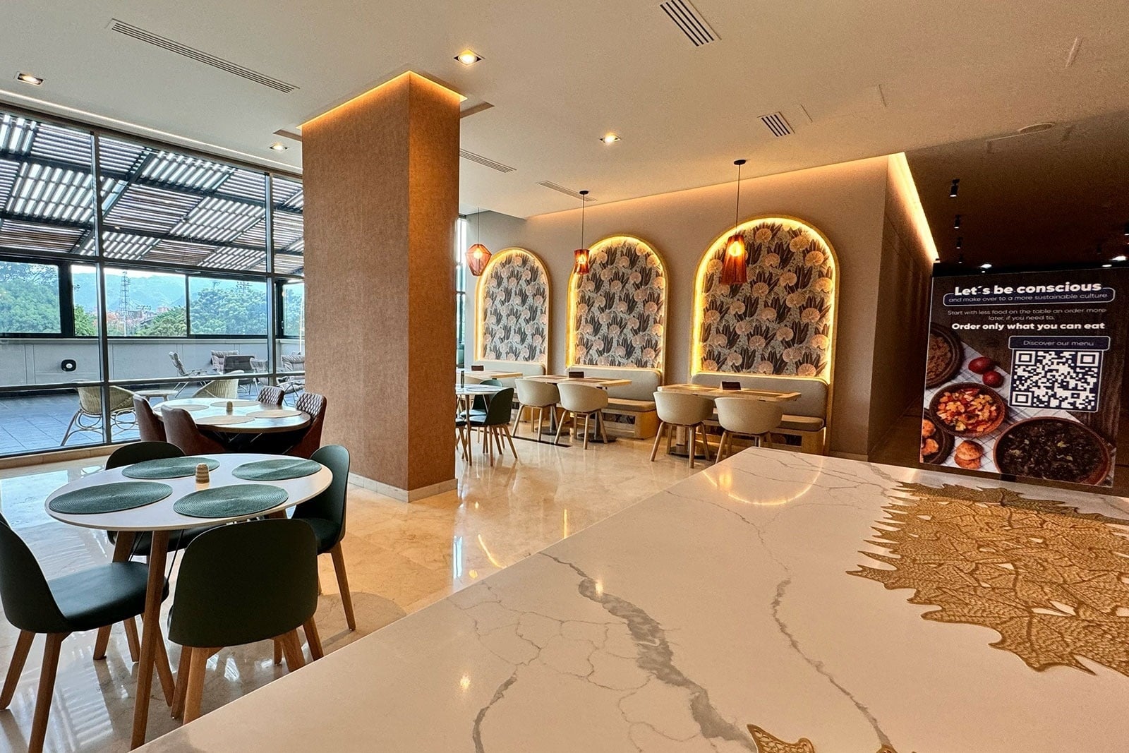 Tequendama Hotel Medellín: Stylish dining area with natural light and green accents.