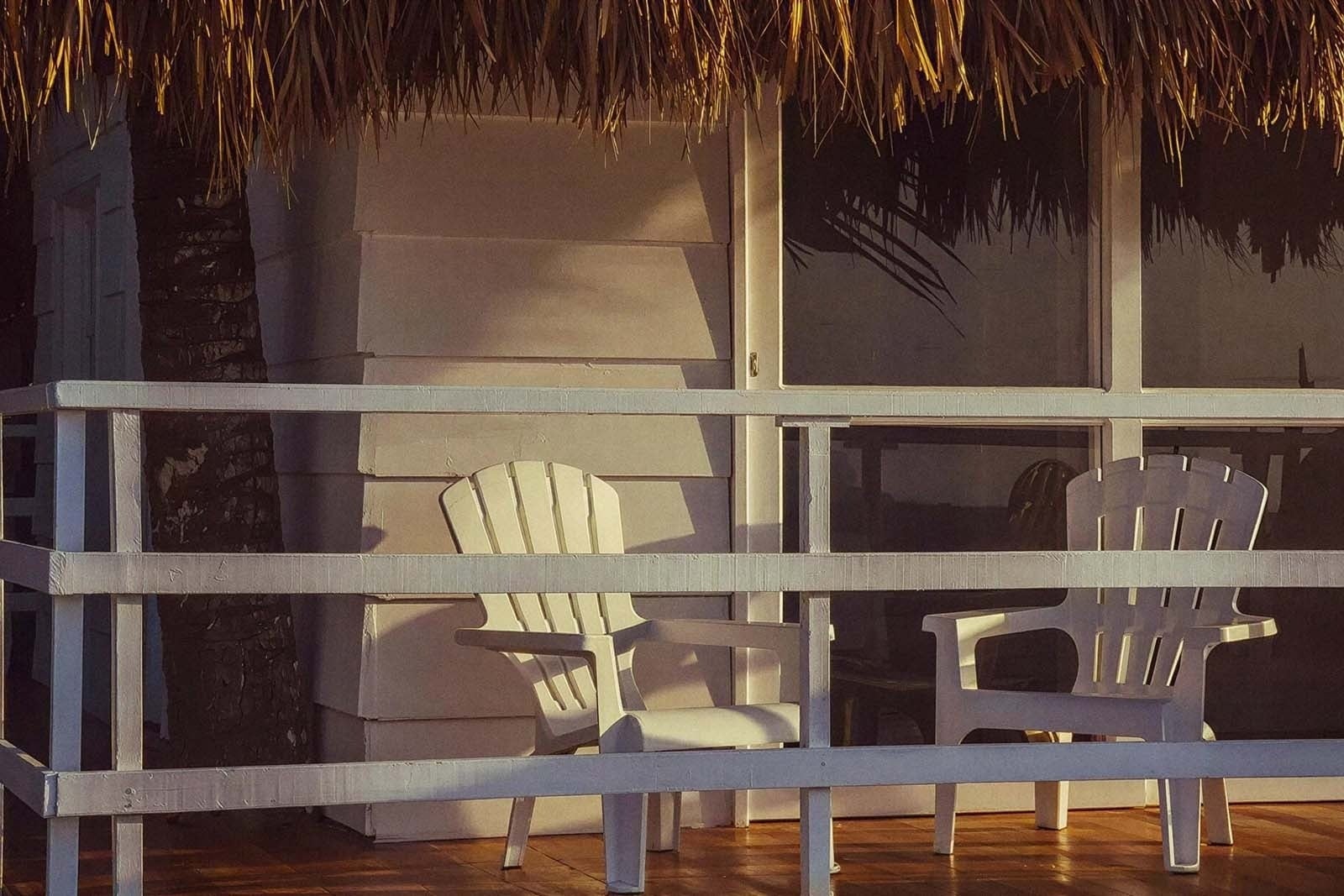 Marine Beach Club & Hotel: Adirondack chairs on a wooden deck, resort backdrop.
