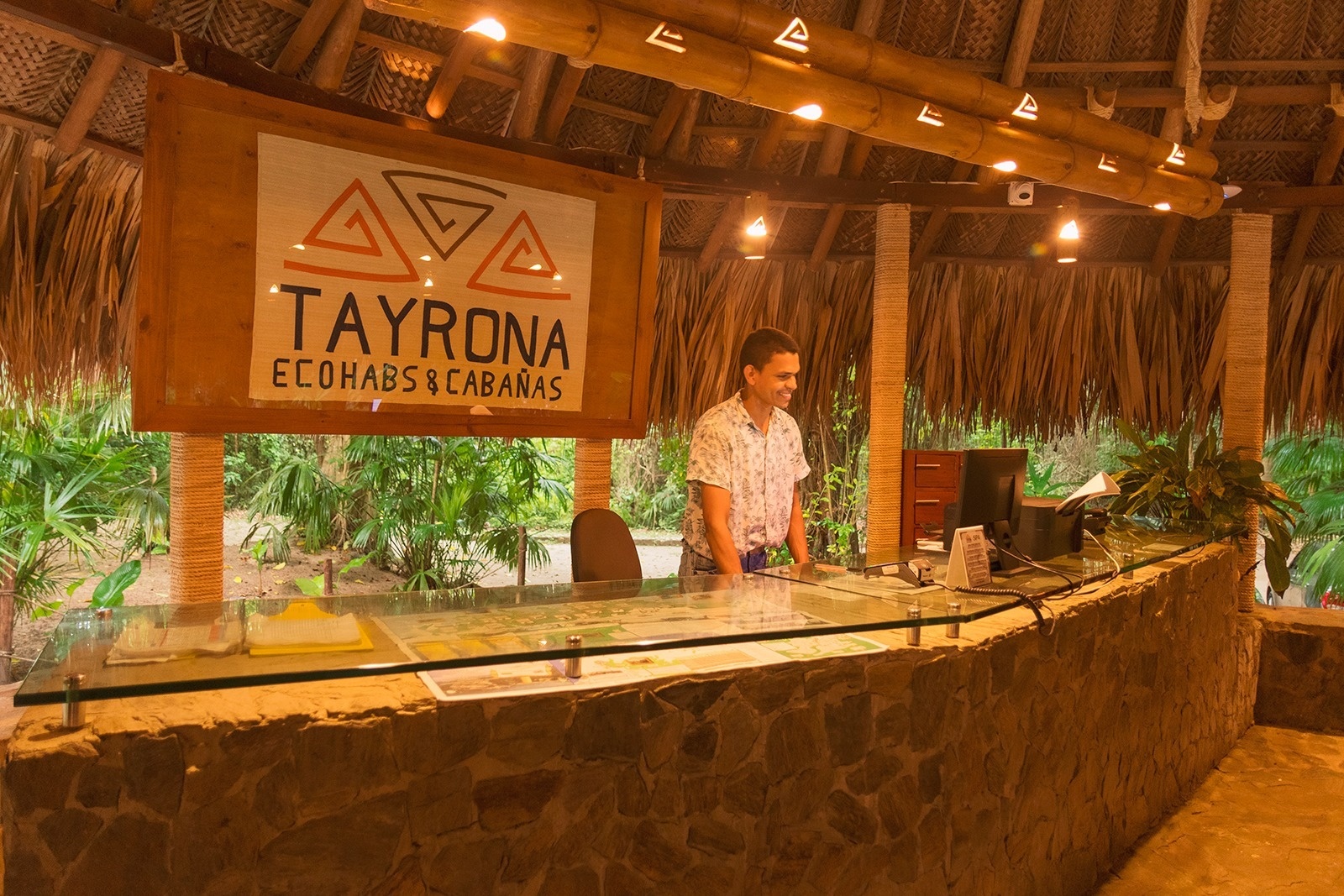 Reception desk at Ecohabs Tequendama | Tayrona Park Eco-Hotel with friendly staff.