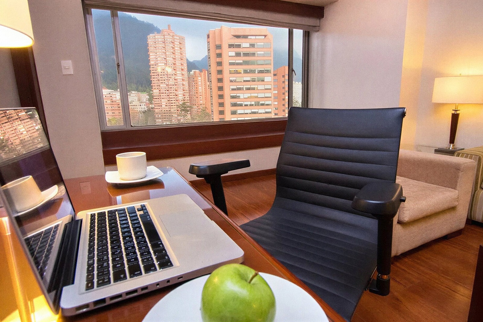 Work desk with laptop & city view at Tequendama Suites Bogotá | Suites in the centre of Bogotá.