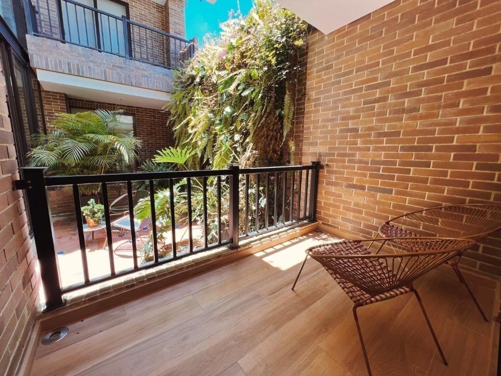 Balcony with chairs overlooking lush greenery at Casa Rosé Hotel | Boutique Hotel in El Carmen de Viboral.