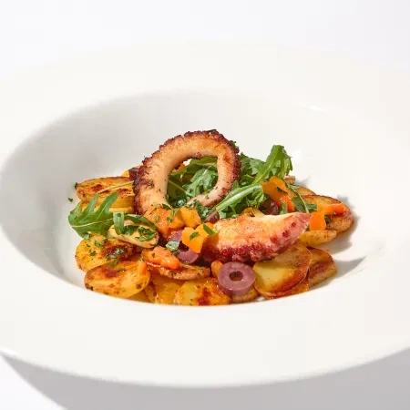 Grilled octopus with crispy potatoes and arugula at Tequendama: Corporativa