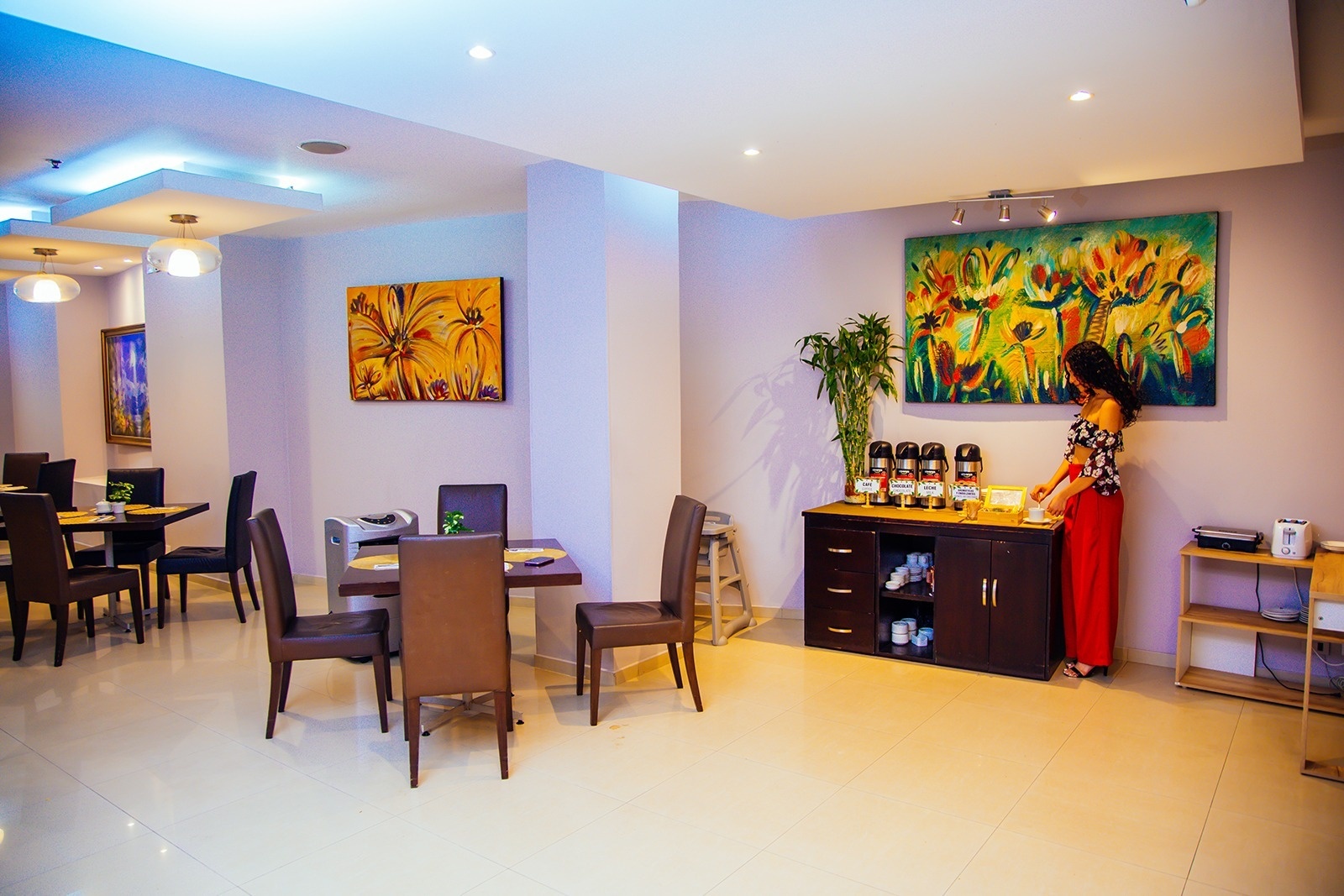 Hotel Plaza Las Américas: Enjoy a vibrant breakfast area with artwork and coffee service.