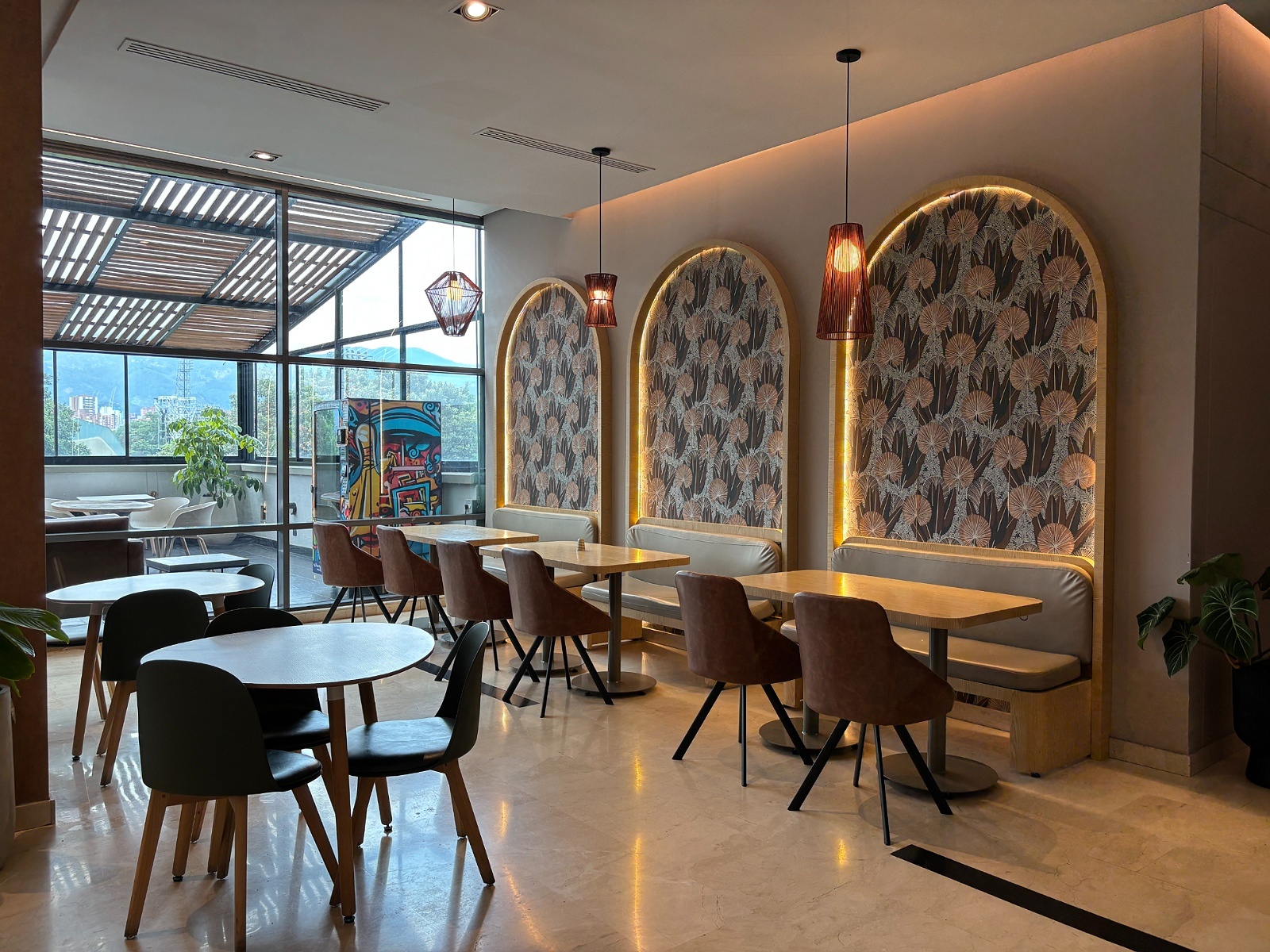 Tequendama: Corporativa modern seating area with arched booths and garden views.