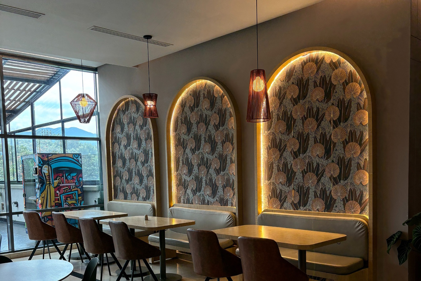 Chic dining area at Tequendama: Corporativa with arched wall panels and modern lighting.