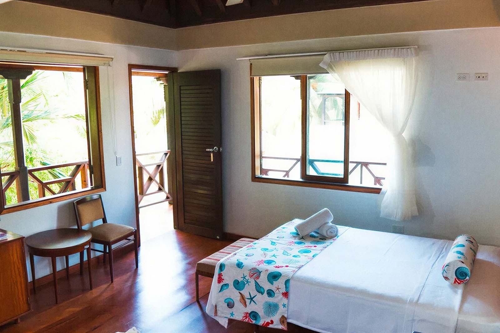 Hotel Rosario de Mar: Bright room with bed, balcony, and tropical views.