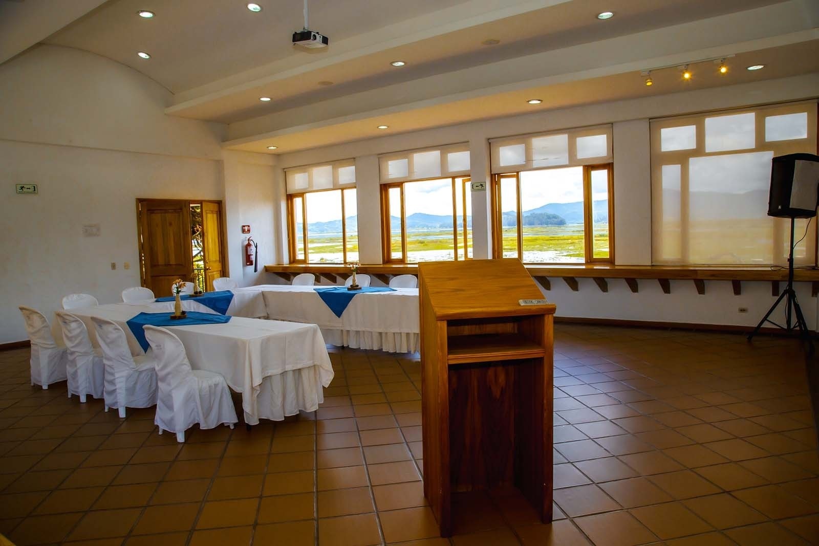 Tequendama Corporate room with lake view and tables set for events.