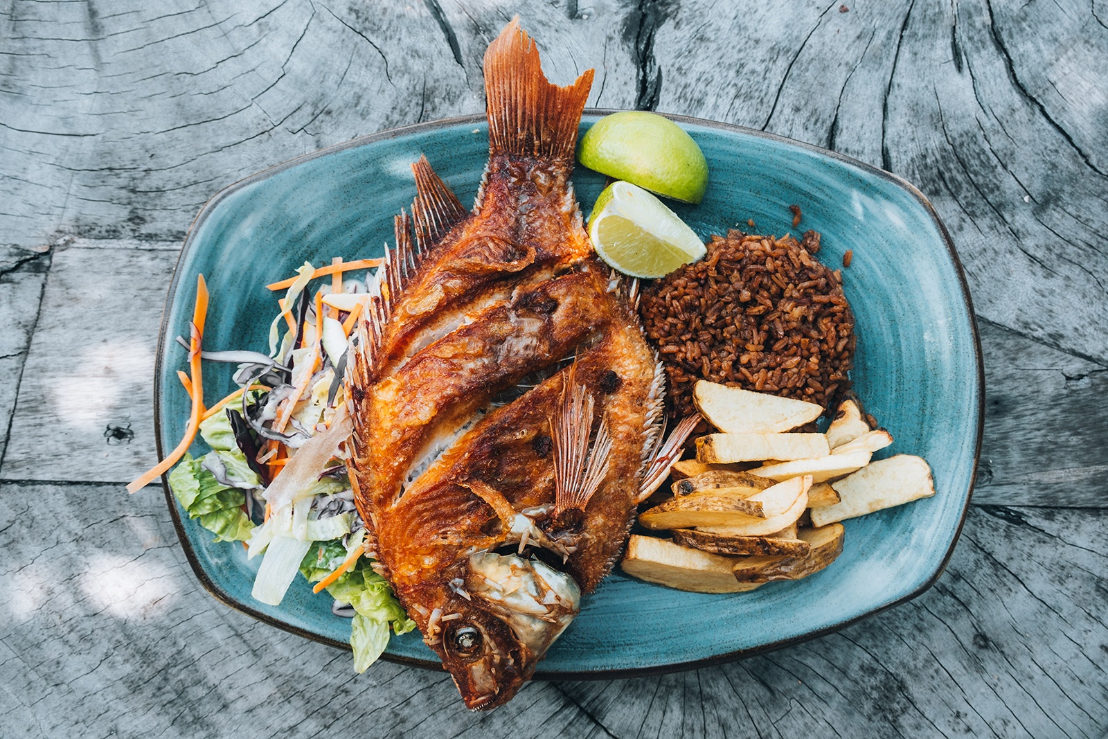 Fried whole fish with rice, fries, and lime at Tequendama: Corporativa.